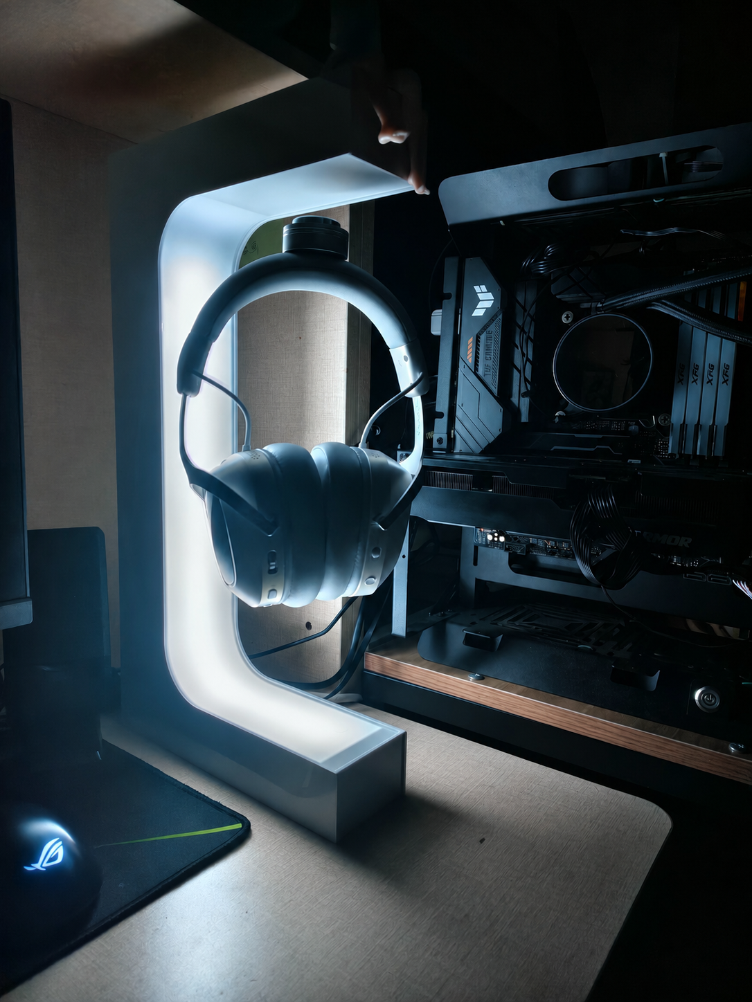 Beacon 01 glowing in a premium real desktop setup beside a PC